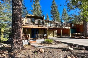 a house with a deck in the woods at Pet-Friendly Cottage, Walk From Big Bear Village! in Big Bear Lake