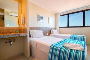 Postel nebo postele na pokoji v ubytování Acqua Inn Maceió Ponta Verde