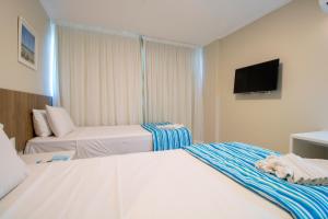 Postel nebo postele na pokoji v ubytování Acqua Inn Maceió Ponta Verde