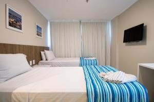 Postel nebo postele na pokoji v ubytování Acqua Inn Maceió Ponta Verde
