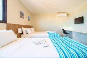 Postel nebo postele na pokoji v ubytování Acqua Inn Maceió Ponta Verde
