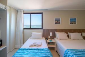 Postel nebo postele na pokoji v ubytování Acqua Inn Maceió Ponta Verde