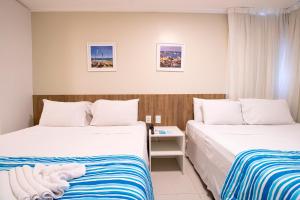 Postel nebo postele na pokoji v ubytování Acqua Inn Maceió Ponta Verde