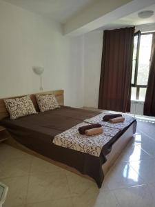 a bedroom with a large bed with two pillows on it at Villa "Pita" in Kiten
