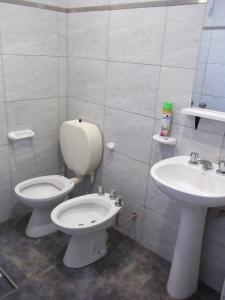 a bathroom with a toilet and a sink at EVA Apartments 3 in San Rafael +27 photos