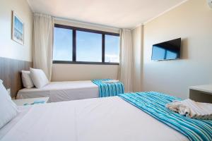 Postel nebo postele na pokoji v ubytování Acqua Inn Maceió Ponta Verde