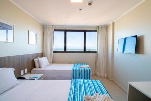 Postel nebo postele na pokoji v ubytování Acqua Inn Maceió Ponta Verde