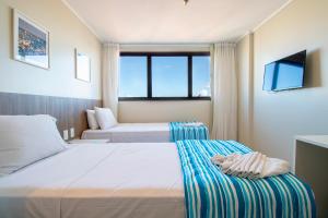 Postel nebo postele na pokoji v ubytování Acqua Inn Maceió Ponta Verde