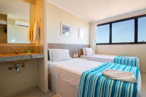 Postel nebo postele na pokoji v ubytování Acqua Inn Maceió Ponta Verde