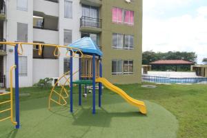 a playground with a slide in front of a building at Relájate o teletrabaja en lindo apto, 3 hab y WiFi in Villavicencio