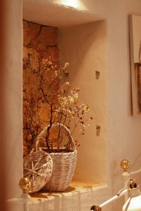 a wicker basket sitting on a shelf in a bathroom at Casa Rústica em Alte - KARMEA HOUSES in Alte