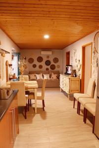 a kitchen and living room with a table and chairs at Casa Rústica em Alte - KARMEA HOUSES in Alte