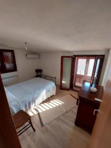 Postel nebo postele na pokoji v ubytování Attico Panoramico Baunei