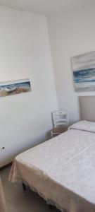 a bedroom with a bed and a picture on the wall at Da Anna in San Teodoro