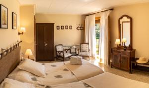 a bedroom with a bed and a table and chairs at Can Rosich in Santa Susanna