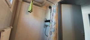 a bathroom with a shower with a shower curtain at Chambre d'hôte L'optimisme in Montfaucon