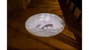 a rug on a floor with two deer in a field at Iroha Grand Hotel Kintetsu Nara Ekimae in Nara