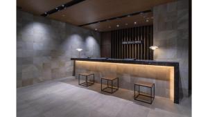 a lobby with a counter and two stools at Iroha Grand Hotel Kintetsu Nara Ekimae in Nara