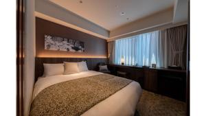 a hotel room with a bed and a window at Iroha Grand Hotel Kintetsu Nara Ekimae in Nara