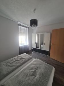 a bedroom with a bed and a dresser and a mirror at Paula Haus Trier in Trier