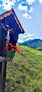 a bird house with a statue of a woman on a hill at Alpbach Loft in Alpbach