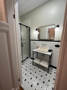 a bathroom with a sink and a mirror at Lipowa Loft Apartments in Sopot