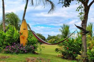 a yellow surfboard sitting in a garden with flowers at Suite Rivas 132 Gran Pacifica Resort in San Diego