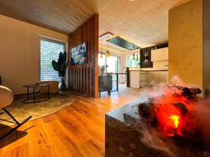 a living room with a fireplace in the middle of a room at Mid Mountain Apartment Tirol in Wiesing