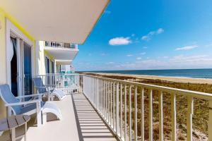 a balcony with chairs and a view of the beach at Adagio 303 in Ocean City