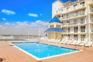 a swimming pool in front of a apartment building at Belmont Towers 505 in Ocean City