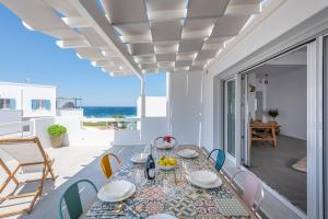 a dining room with a table and chairs at Elyos Apartments in Pollonia