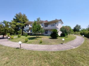 a large house with a winding driveway at Elia Apartments in Oreoi