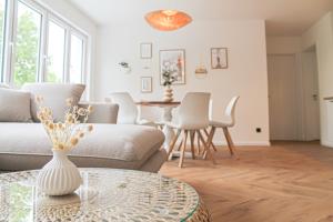 a living room with a couch and a table at Relax Apartment - für Familien, stadtnah, mit Parkplatz in Koblenz