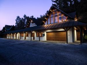 a large house with a garage at night at Chalet Drevarska in Benecko