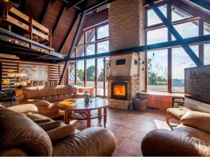 a large living room with couches and a fireplace at Chalet Drevarska in Benecko