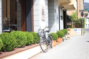 a bike parked on a sidewalk next to a building at Albergo Il Cochino in Montale