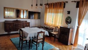 a dining room with a table and chairs in a room at Casa dos Avós in Vouzela