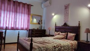 a bedroom with a bed and a pink curtain at Casa dos Avós in Vouzela +74 photos