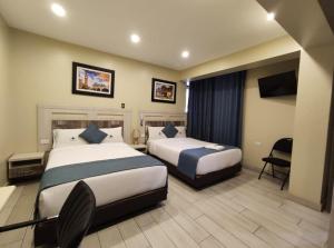 En eller flere senge i et værelse på Hotel Konford Cañete