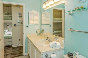 a bathroom with a sink and a mirror at Sea Spray Place in Kure Beach +11 photos