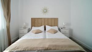 a bedroom with a large bed with two night stands at Casa Canadiana in Baile Felix