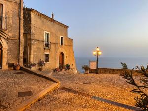 an old building with a street light next to it at Residenza Matilde in Fiumefreddo Bruzio