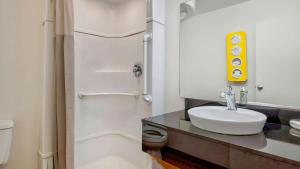 a bathroom with a sink and a toilet and a mirror at Motel 6-Santa Rosa, NM in Santa Rosa +40 photos