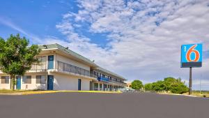 a hotel with a sign in front of a building at Motel 6-Tucumcari, NM in Tucumcari