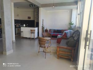 a living room with a couch and a table at RESIDENCIAL CANTINHO PANTANEIRO in Itapoa