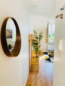 a mirror on a wall in a room at Studio Douillet Hypercentre 12 min de Paris in Enghien-les-Bains