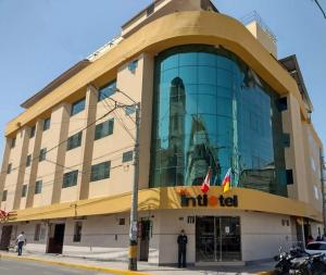 a man is standing in front of a building at Intiotel Piura in Piura