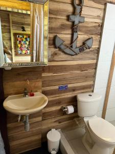 a bathroom with a sink and a toilet at Palm Beach Hostal in Santa Marta