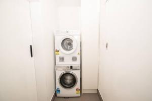 a washing machine and a washer and dryer in a room at Willow Court Unit 1 in Broken Hill
