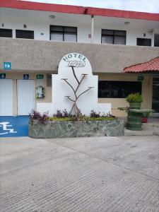 a building with a sign on the side of it at HOTEL MARIA TERESA in Río Verde